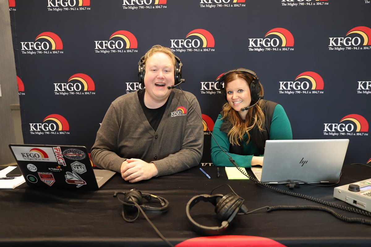 KFGO announcers smiling at event