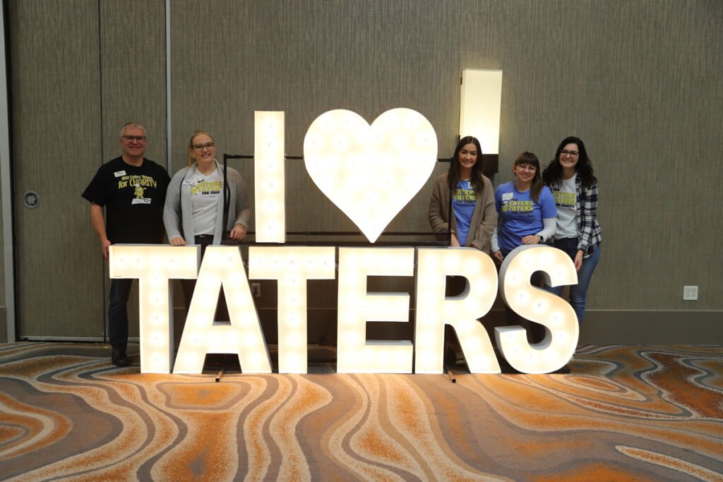 picture of RDO staff in front of I love taters sign