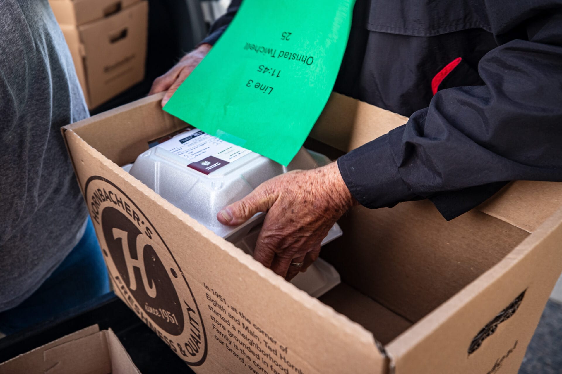 volunteers packing take out at caters taters